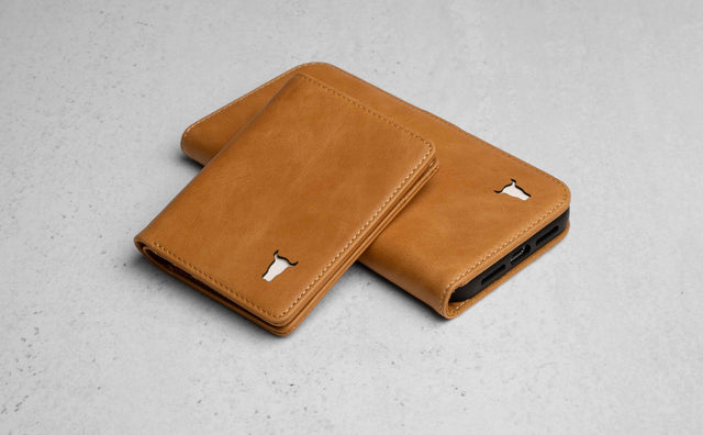 Tan Leather Bifold Wallet resting on a matching Tan Phone Case