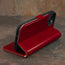 Integrated stand function of the Red Leather Wallet Case for iPhone 15