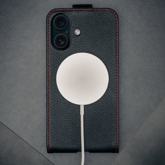 MagSafe charger attached to the Black with Red Stitching Leather Flip Case for iPhone 16