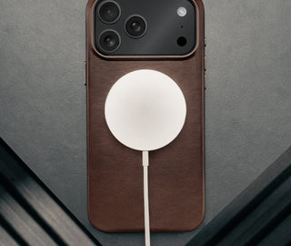 MagSafe charger attached to the Slimline Dark Brown Leather Bumper Case for iPhone 17 Pro