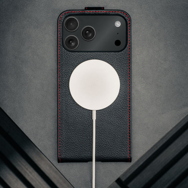 MagSafe charger attached to the Black with Red Stitching Leather Flip Case for iPhone 17 Pro Max