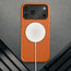 MagSafe charger attached to the Slimline Orange Leather Bumper Case for iPhone 17 Pro