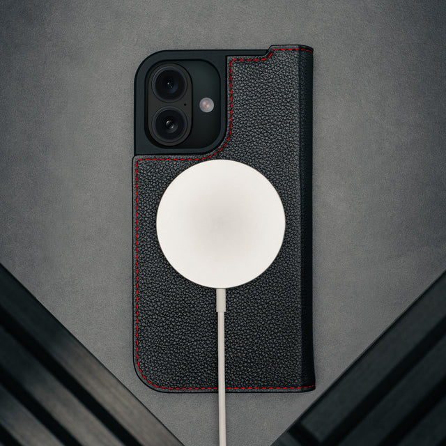 MagSafe charger attached to the Black (with Red Detail) Leather Case for iPhone 17