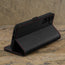 Stand function of the Black with Red Detail Leather Wallet Case for Samsung Galaxy S24 Plus
