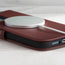 MagSafe charger attached to the Burgundy Leather Folio Case (MagSafe) for iPhone 14 Pro Max