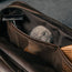 Close up of items in the mesh pockets inside the Dark Brown Leather Wash Bag