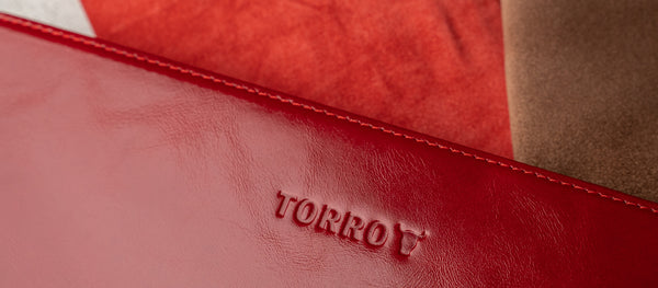 TORRO logo on a red leather accessory