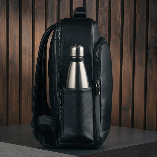 Side view of the Black Leather Backpack with metallic water bottle