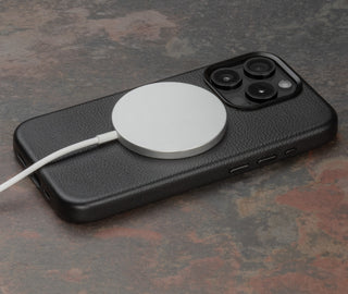 MagSafe charger attached to the Black Slimline Leather Bumper Case for iPhone 15 Pro
