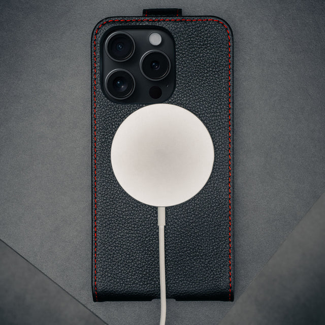 MagSafe charger connected to the Black with Red Stitching Leather Flip Case for iPhone 16 Pro