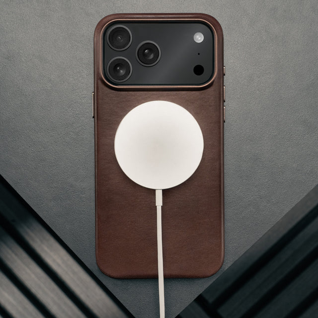 MagSafe charger attached to the Slimline Dark Brown Leather Bumper Case for iPhone 17 Pro Max
