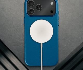 MagSafe charger attached to the Slimline Cobalt Blue Leather Bumper Case for iPhone 17 Pro Max