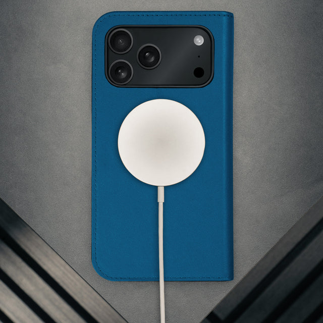 MagSafe charger attached to the Cobalt Blue Leather Case for iPhone 17 Pro Max