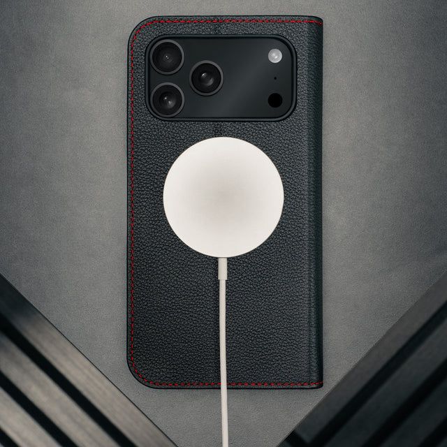 MagSafe charger attached to the Black Leather Case (with Red Stitching) for iPhone 17 Pro