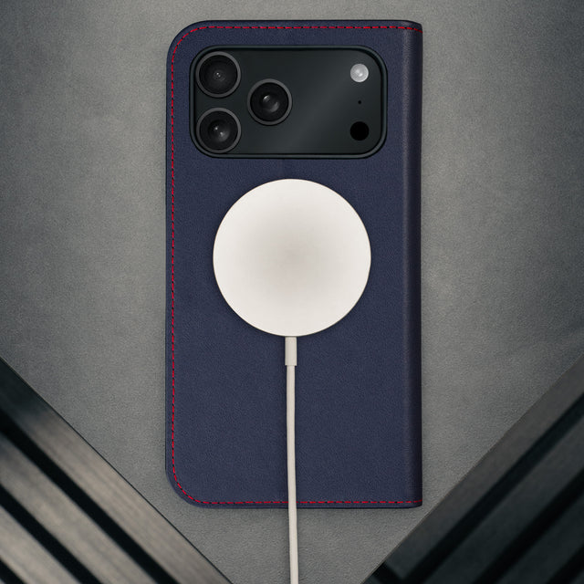 MagSafe charger attached to the Navy Blue Leather Case for iPhone 17 Pro