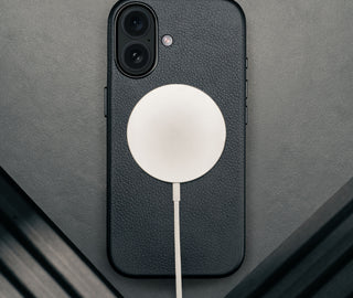 MagSafe charger attached to the Black Leather Bumper Case for iPhone 17