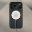 MagSafe charger attached to the Black Leather Bumper Case with Rotating Stand for iPhone 17 Pro Max