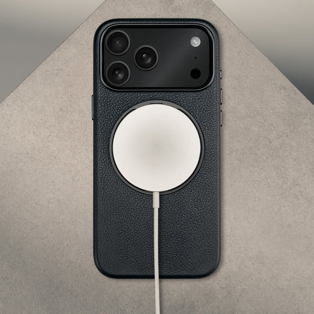 MagSafe charger attached to the Black Leather Bumper Case with Rotating Stand for iPhone 17 Pro