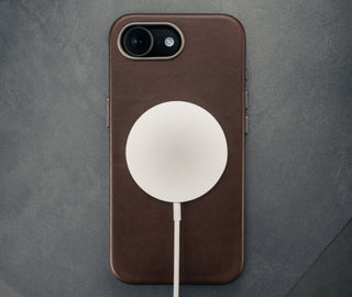 MagSafe charger attached to the Dark Brown Slimline Leather Bumper Case for iPhone SE4 (2025)