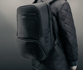 Man carrying the Black Commuter Backpack
