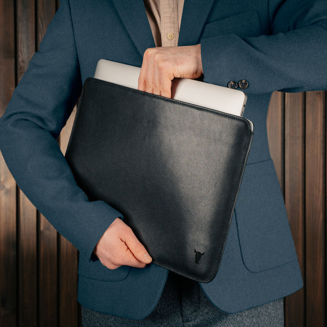Man taking laptop out of the Black Leather MacBook Pro / MacBook Air Sleeve