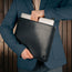 Man taking laptop out of the Black Leather MacBook Pro / MacBook Air Sleeve