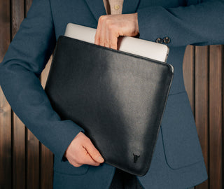 Man taking laptop out of the Black Leather MacBook Pro / MacBook Air Sleeve