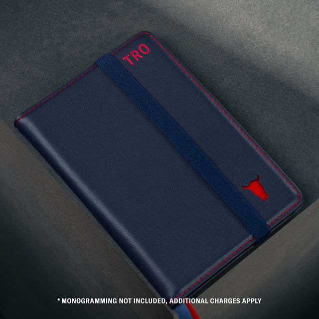 Close up of the TORTO bulls head logo on the front of the Navy Blue Leather (with Red Stitching) Passport holder
