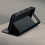 Stand function of the Black with Red Stitching Leather Case for the Google Pixel 11