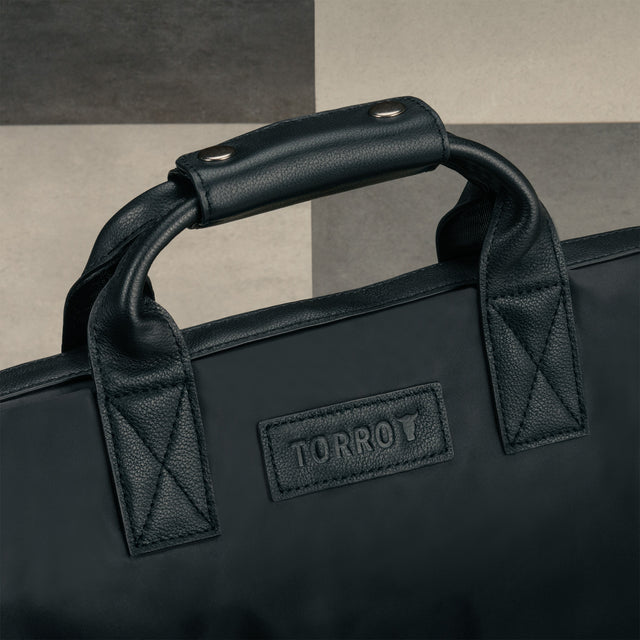 Leather carry handles on the Black Trifold Canvas Suit Carrier / Garment Bag