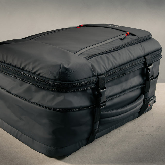 Showing the expandable section of the Black eith Red Detail Travel Backpack