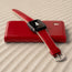 Red Leather Strap for Apple Watch lying on a red phone case