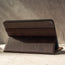Demonstrating the integrated stand function of the Dark Brown Leather Stand Case for iPad 10.2