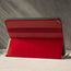 Demonstrating the integrated Stand function of the Red Leather Stand Case for iPad 10.2