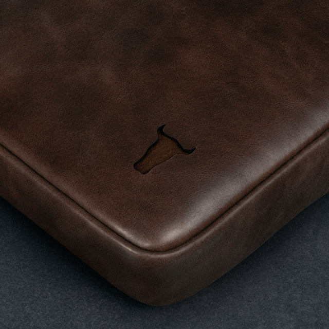 Dark Brown Leather Messenger Bag on a wooden table