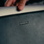 Close up of the TORRO logo on the back of the Leather Laptop Sleeve for 13