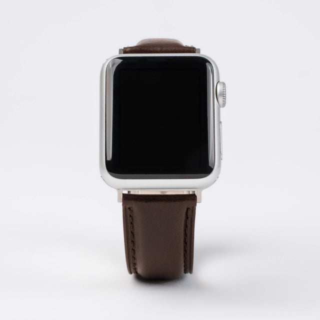 Close up of an Apple Watch with a Dark Brown Leather Strap