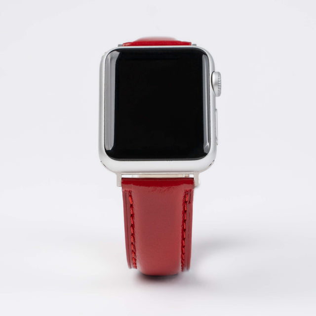 Close up of an Apple Watch with a Red Leather Strap