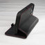 Integrated stand function of the Black (with Red Stitching) Leather Folio Stand Case for iPhone 14