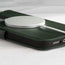 MagSafe charger attached to the Racing Green Leather Folio Case (MagSafe) for iPhone 14 Pro Max