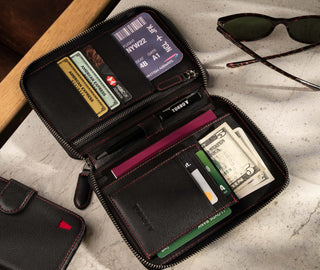 Inside of the Black Leather with Red Stitching Solo Travel Wallet showing multiple cards, boarding pass, passport and money