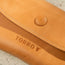 Close up of the pop button closure on the Tan Leather Sunglasses Case